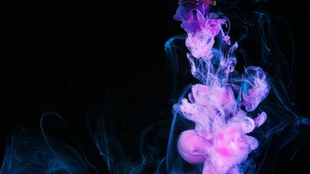 Gentle flow of paint in water. Stock footage. Close-up of beautiful pink ink floating smokily in...