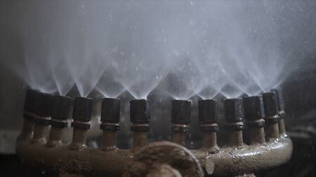Close up of water fountain mechanism. Clip. Metal pipes of the working fountain with streams of...