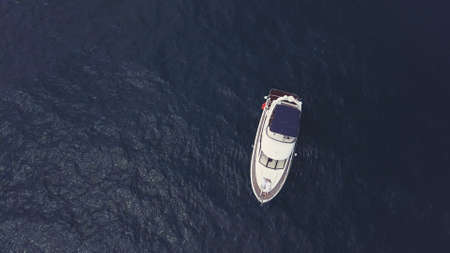 Amazing view to yacht sailing in open sea on a suny day. Video. Aerial top view of a white luxury...