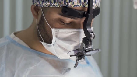 Portrait of a professional doctor in operating room during procedure, concept of medicine. Action....