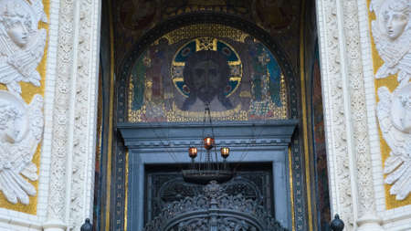 Details of arched main entrance to Cathedral. Concept. Beautiful detailed entrance with arched vault and iconostasis in Cathedral. Wrought-iron gates to temple and bas-reliefsの写真素材