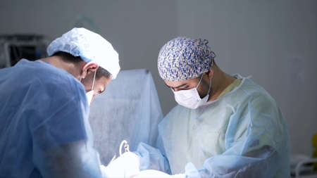 Surgeons cauterize wounds. Action. Professional surgeons carry out concentration operation under...