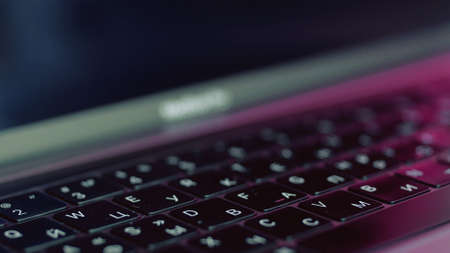 Silver laptop with black keybord details. Action. Close up of a new modern laptop, concept of technological progress and technologies.の写真素材