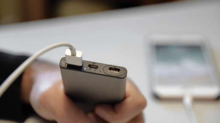 Close-up of connecting charging to your phone. Media. Special charging connector for branded phone....