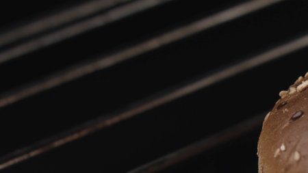 Close up of metal rods inside the oven with open fire. Stock footage. Dirty steel rods with fat isolated on black background with hot flame.の写真素材