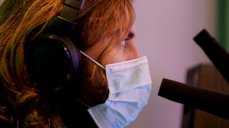 Close up of radio, DJ, or sport event TV show commentator talking on the air. Media. Side view of a...