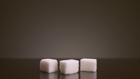 Pile of sugar cubes on isolated background. Stock footage. Pile of sugar cubes changes in number on isolated background. Sweets in large quantities are harmful to health. Sugar and sweets are 21st century addiction.の写真素材