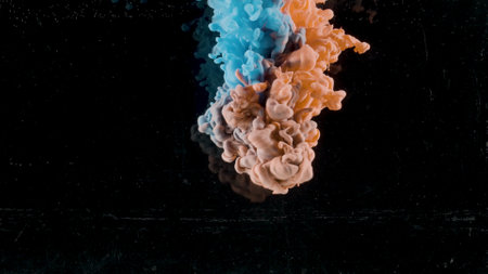 Collision of colored inks with water. Action. Beautiful colorful background the collapse of liquid paints with water in slow motion on a black background.の写真素材