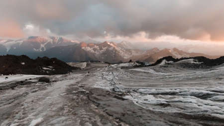 Winter wild landscape from the high mountain top to the ice covered slope and cloudy sky. Clip....