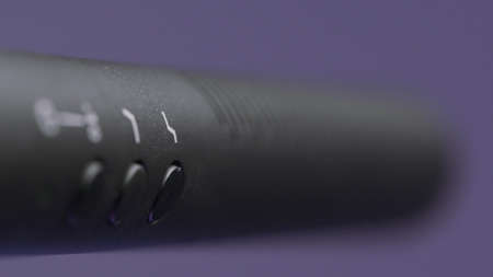 Recording microphone in audio recording studio. Action. Close up moving focus along the microphone...