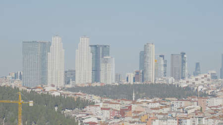 Panoramic view of modern city on sunny day. Action. Developed city with skyscrapers on horizon towering over city. Big city with contrast of skyscrapers and houses in summerの写真素材