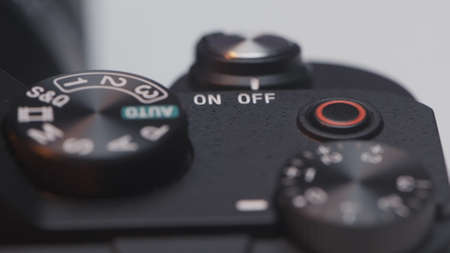 Close up of DSLR camera buttons and dials. Action. Details of a new professional camera on white background.の写真素材