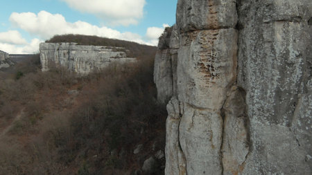 Aerial view of amazing stone cliffs on blue cloudy sky background. Shot. Autumn landscape with...