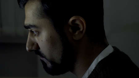 Close up side view of a businessman or programmer typing on laptop keyboard at a desk in the office....