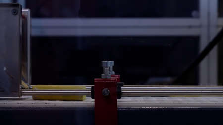 Close up side view of a modern conveyor line with moving yellow bricks. HDR. Industrial background with a conveyor belt and colorful briquettes.の写真素材