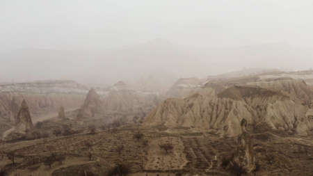 Aerial view of Cappadocia landscape, Turkey. Action. Goreme National Park on a foggy and rainy day, unusual beauty of rock formations.の写真素材