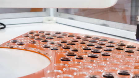 Pharmaceutical manufacturing automatic machine, covid 19 coronavirus vaccine production equipment. HDR. New technologies in pharmacy medical industry concept.の写真素材