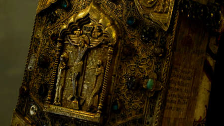 Close up of the ancient Bible book with golden cover . Concept. Details of the Orthodox church interior, history and religion.の写真素材