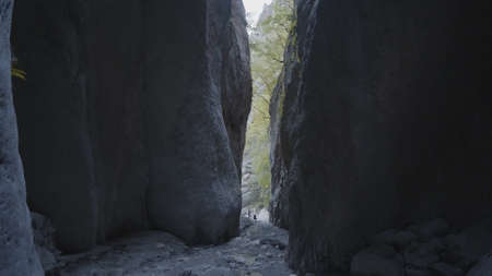 Narrow gorge in rocks. Action. Narrow passage between rocks in mountains. Mountain passes through rocks. Frightening and dangerous narrow gorges in mountainsの写真素材