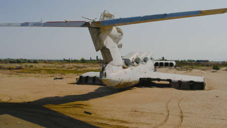 Abandoned plane on shore. Action. Old military plane standing in tropics. Abandoned plane landed on...