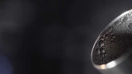 Teapot spout with drops. Action. Close-up of beautiful drops on spout of boiling kettle. Beautiful metal spout of new teapotの写真素材