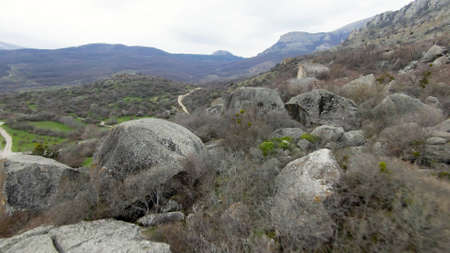 Boulders at foot of mountain. Shot. Drone view of extreme flight over boulders and rocks on mountain...