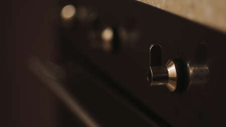 Close up of handles of the black gas stove in the kitchen. Concept. House utensils and cooking food at home.の写真素材