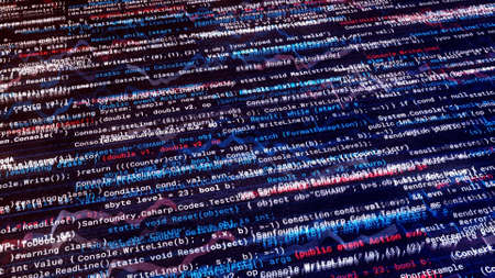 Many narrow lines of abstract program code are written automatically on black background. Animation. Working program code, software and internet concept.の写真素材
