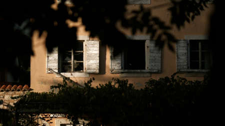 The view from the drone. Creative. A beautiful brick architectural building with green vegetation nearby and open dark windowsの写真素材