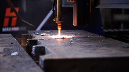 Cutting metal with a laser. Clip . A thick laser beam cuts metal and everything sparkles.の写真素材