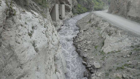 A powerful stream of water is squeezed between the sides of the rocks. Action. Aerial view of the...