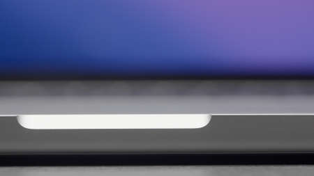 Extreme close up of a laptop with blurred screen. Action. Details of an opened portable computer...