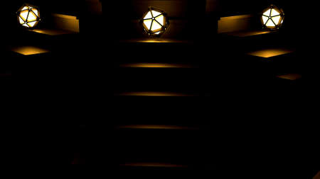 Dark background. Design. Three stairs without light with three glowing green and yellow balls that roll down and fall .の写真素材