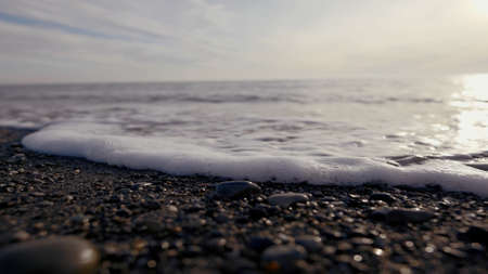 Beach. Action. Beautiful waves of the sea running along the stone and you can see the foam from the...