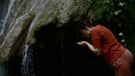 Amazing beautiful waterfall in deep cave at the chinese national park. Creative. Side view of a...