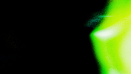 Dark background with a laser ring. Motion. Green and purple lines of laser beams that move in different directions in the animation.の写真素材