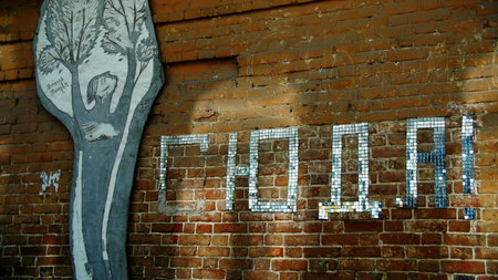 Red brick wall with letters and art painting. Stock footage. Concept of street art.の写真素材