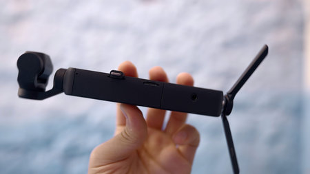 Accessory for shooting. Action. A small camera that is attached to a special tripod and taken in...