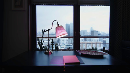 Home office with plants in evening. Creative. Beautiful home office interior with evening lighting. Expensive interior of home office with lampsの写真素材