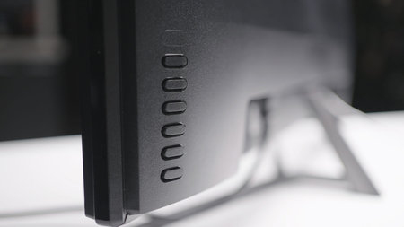Close-up of buttons behind monitor. Action. Buttons behind computer monitor. TV or computer monitor...