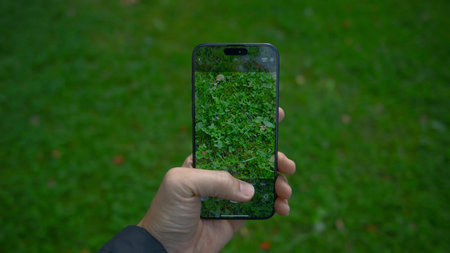 China, Beijing - September 15, 2023: iPhone 15 Pro screen shooting grass. Action. Close-up of phone display taking pictures of nature. Clear image on screen of shooting phoneのeditorial素材