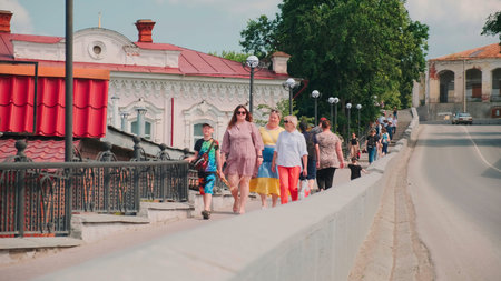 Serbia, Belgrade - June 15, 2023: Street with walking people and modern sights on summer day. Clip....