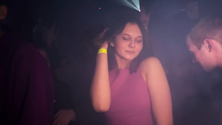 Serbia, Belgrade - June 20, 2023: Beautiful young woman dancing in club. Clip. Attractive woman is...