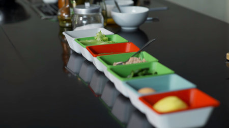 Close-up of ingredients in plates before cooking. Art. Small plates with cooking ingredients. Ingredients for cooking in professional kitchenの写真素材
