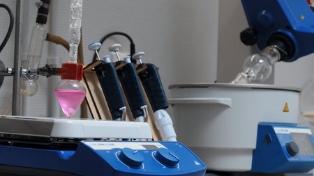 Equipment in chemical laboratory with rotating flasks. Stock footage. Rotating equipment and colored...