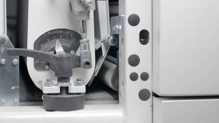 Close-up of conveyor machine with pressure indicator. Creative. Moving conveyor line with pressure....