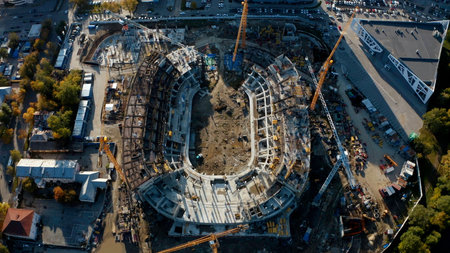 Process of building a stadium, aerial top view. Stock footage. Construction site, creation of metal structures during the construction of a stadium.の写真素材
