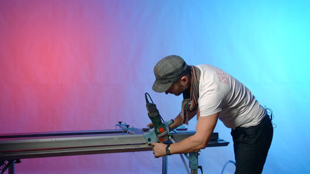Man works at modern carpentry table. Creative. Modern carpentry table with fixing fasteners and...