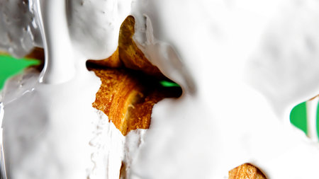 Concept of delicious breakfast. Stock clip. White glaze draining down the freshly baked croissants, close up view.の写真素材