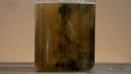 Test tube close up. Black liquid in the flask. The liquid in the flask changes colorの写真素材